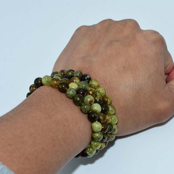 Layered Green Garnet Bracelets wrapped on wrist with polished finish