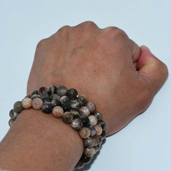 Layered Black Sunstone Bracelets on wrist for stacked style look