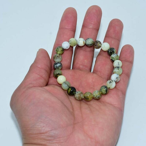 Green Opal Bracelet held in hand showing natural bead colors