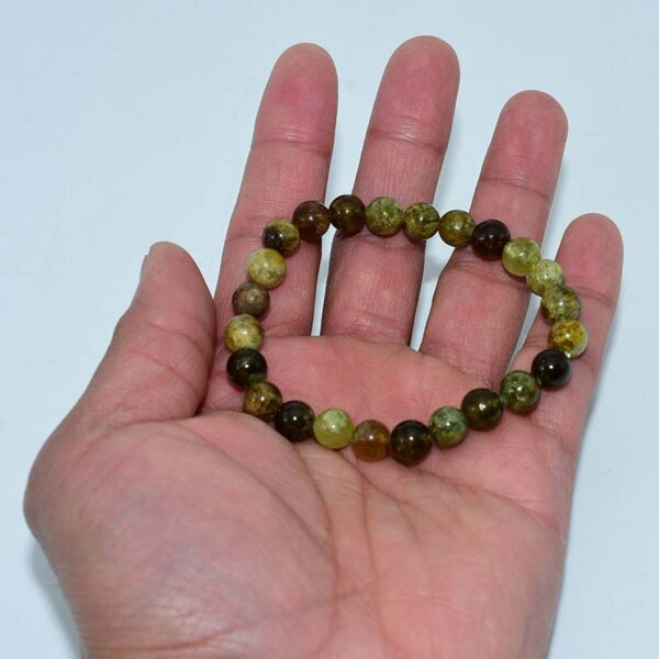 Green Garnet Bracelet held in hand showing natural Tsavorite bead texture
