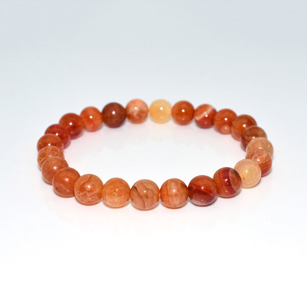 Dragon Vein Agate Bracelet laid flat with round orange gemstone beads