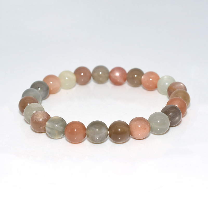 Close-up of Peach Moonstone Bracelet beads showing natural color mix and surface details
