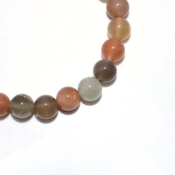 Close-up of Peach Moonstone Bracelet beads showing natural color mix and surface details