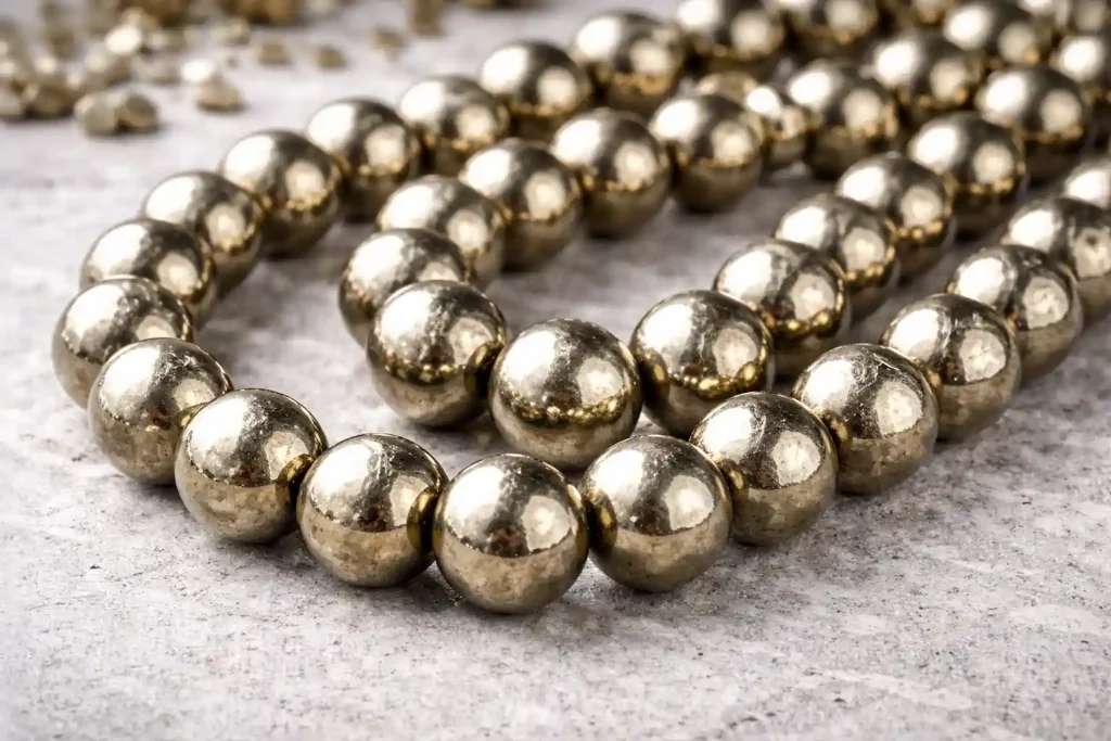 Pyrite strand beads in polished metallic finish—Pyrite Stone Benefits for jewelry making and wholesale supply.