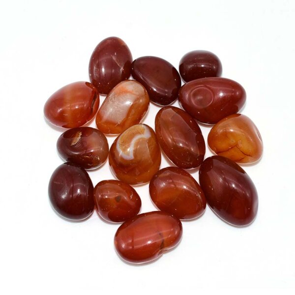 Group of smooth red striped Tumbled Carnelian stones on white background