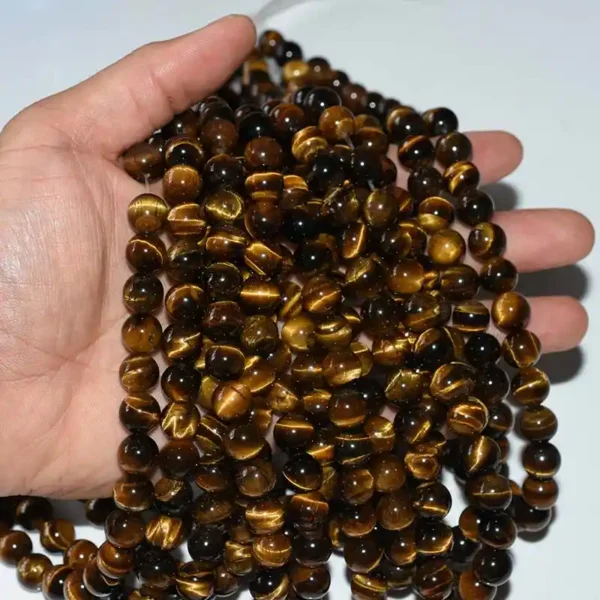 Authentic Tiger Eye Beads in hand showing natural golden brown color