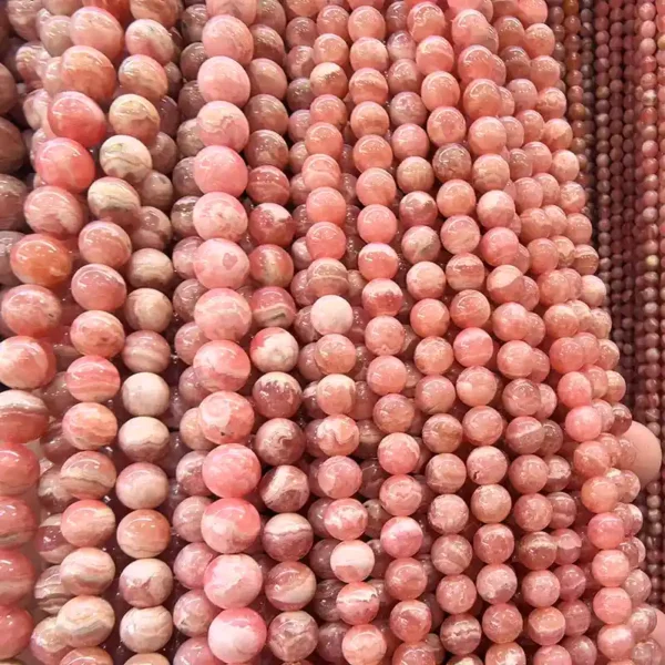 Close-up of Rhodochrosite Beads strands 6mm, polished pink gemstone beads