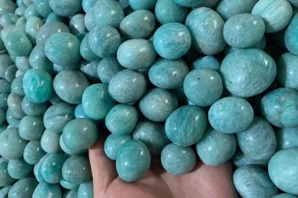 Amazonite Bracelet Benefits – close view of tumbled amazonite stones 2–3 cm with natural veining