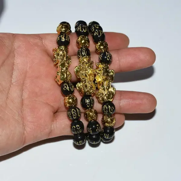 Feng Shui Obsidian Bracelet with two layers displayed in hand