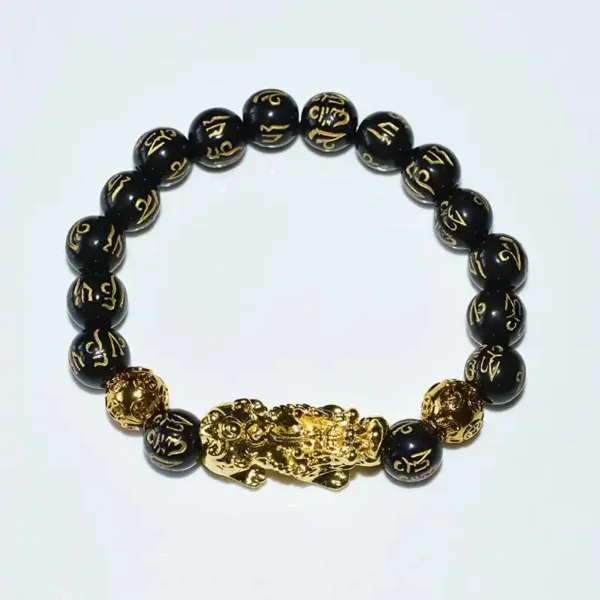 Single Feng Shui Obsidian Bracelet with golden Pixiu on white background