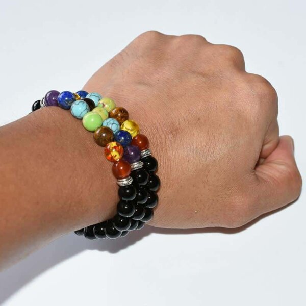Black Tourmaline Chakra Bracelet displayed on palm with colorful chakra beads