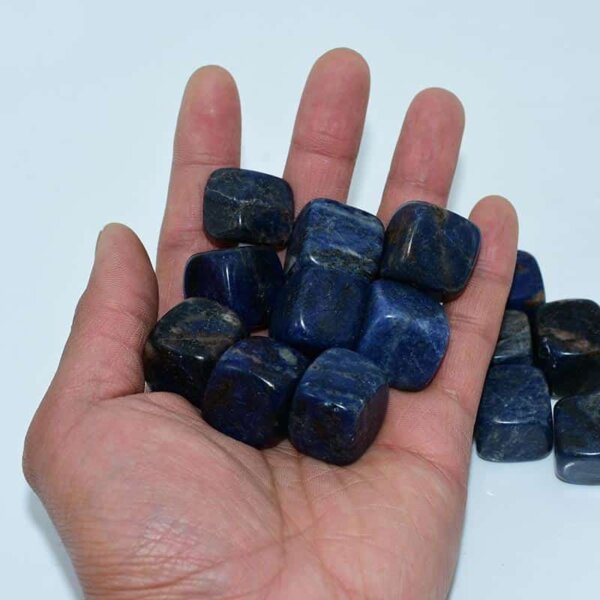 Blue Sodalite Cube stones resting on palm