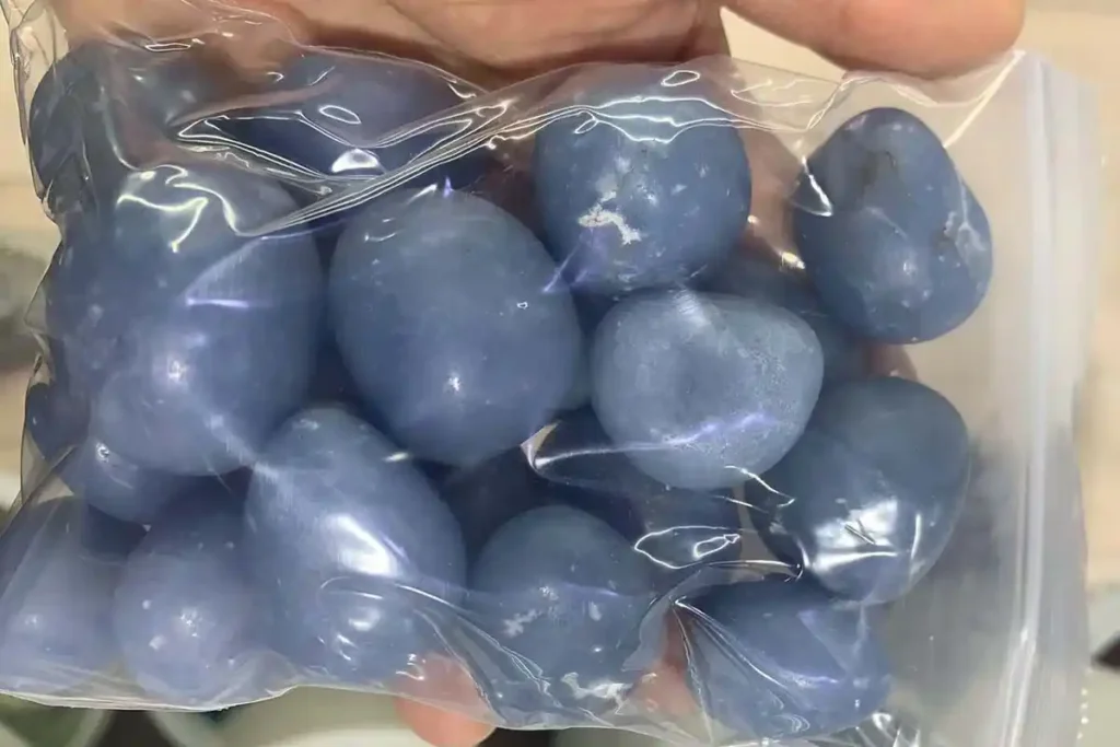 Angelite Stone Meaning – Tumbled Angelite healing crystals in hand