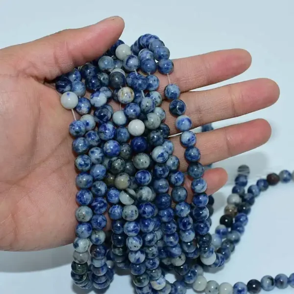 Hand holding natural Sodalite Beads strands – wholesale gemstone beads for bracelets and necklaces