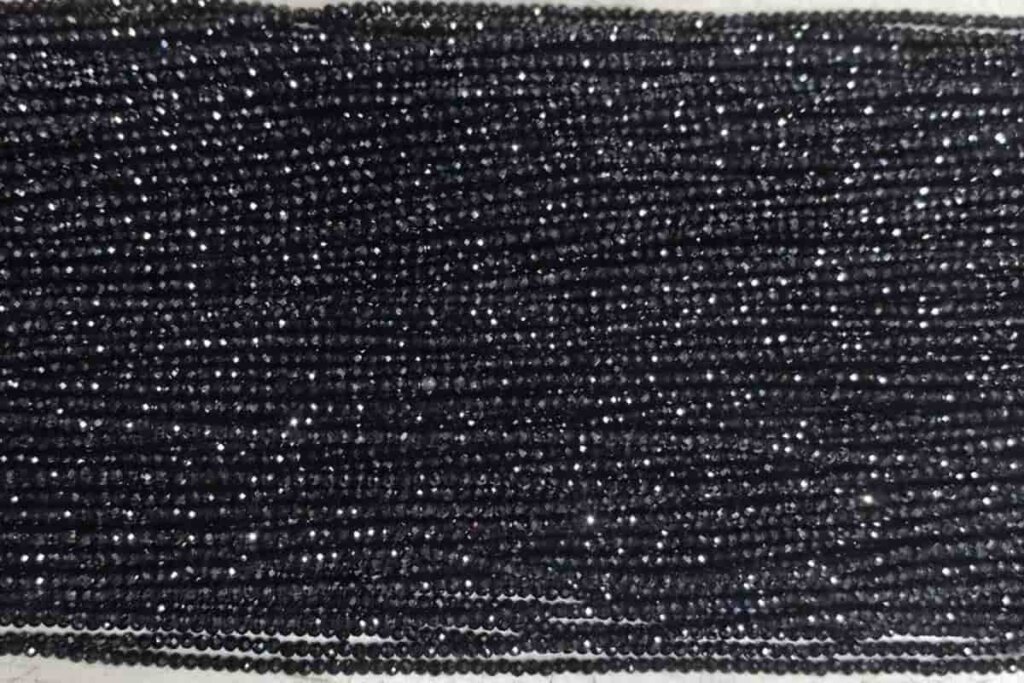3mm faceted Black Spinel beads showing the brilliance and meaning of Black Spinel gemstone for protection and strength