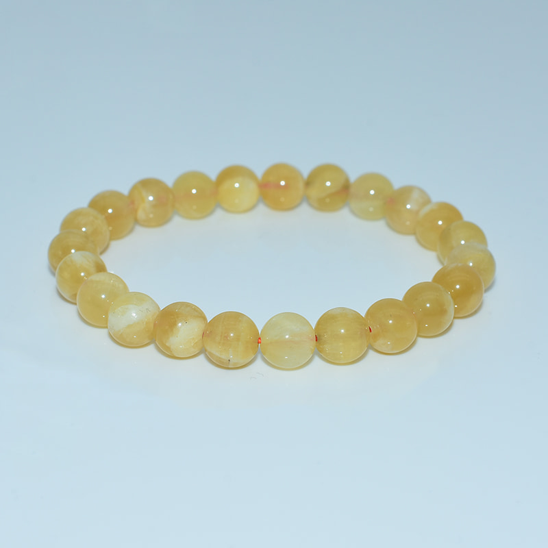 8mm Orange Calcite Bracelet — smooth polished round beads with warm orange glow