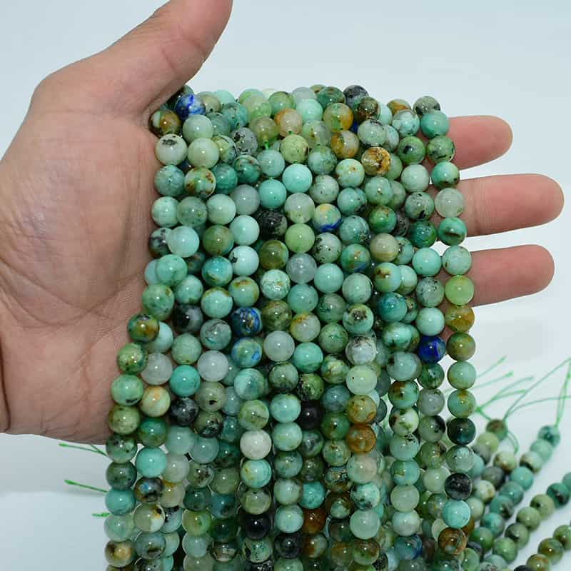 Azurite Chrysocolla 8mm beads shown in hand, natural blue-green gemstone strands for jewelry making