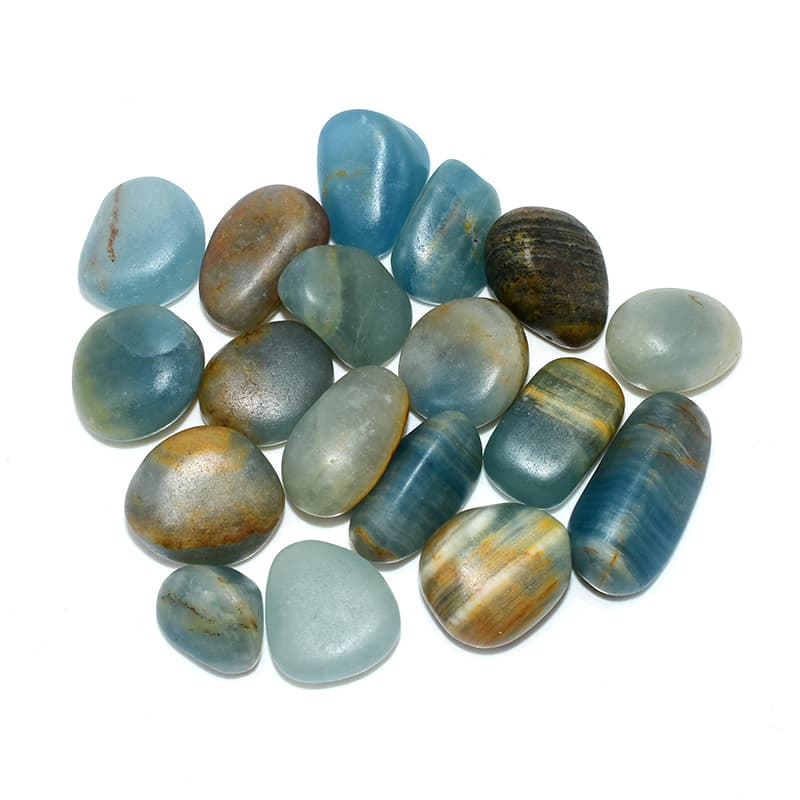 Top view of Blue Calcite Tumbled stones arranged in group, showing blue hue and round shape.