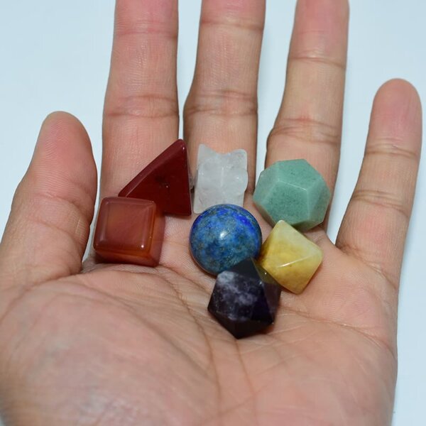 Chakra Crystal Set in hand showing seven colorful energy stones for chakra healing