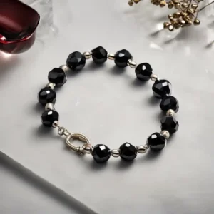 Elegant faceted Black Spinel bracelet with charm, symbolizing protection and energy in the Black Spinel meaning