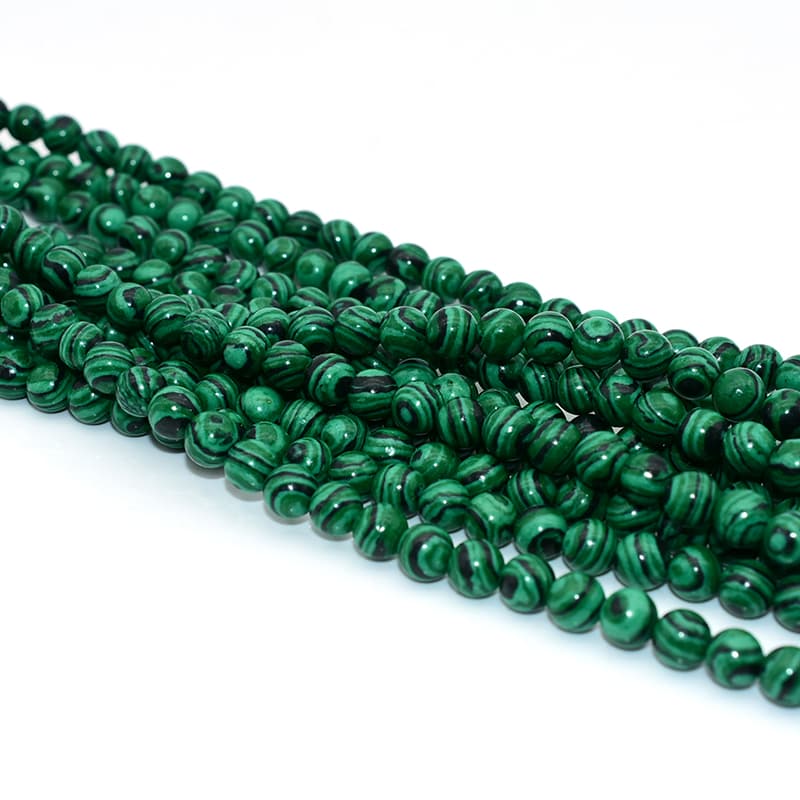 Fake Malachite Beads photographed from a different angle with natural light reflection