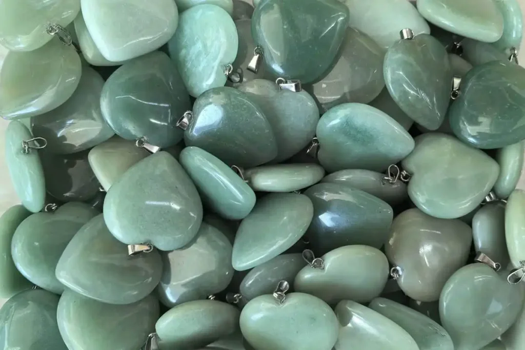 Green Aventurine Benefits for love and emotional healing shown in a heart-shaped pendant.