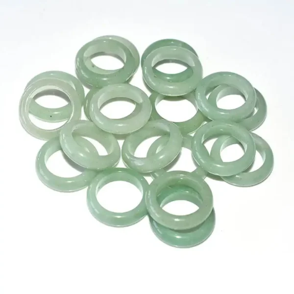 Several Green Aventurine Rings displayed on white background to show stone clarity and color consistency.