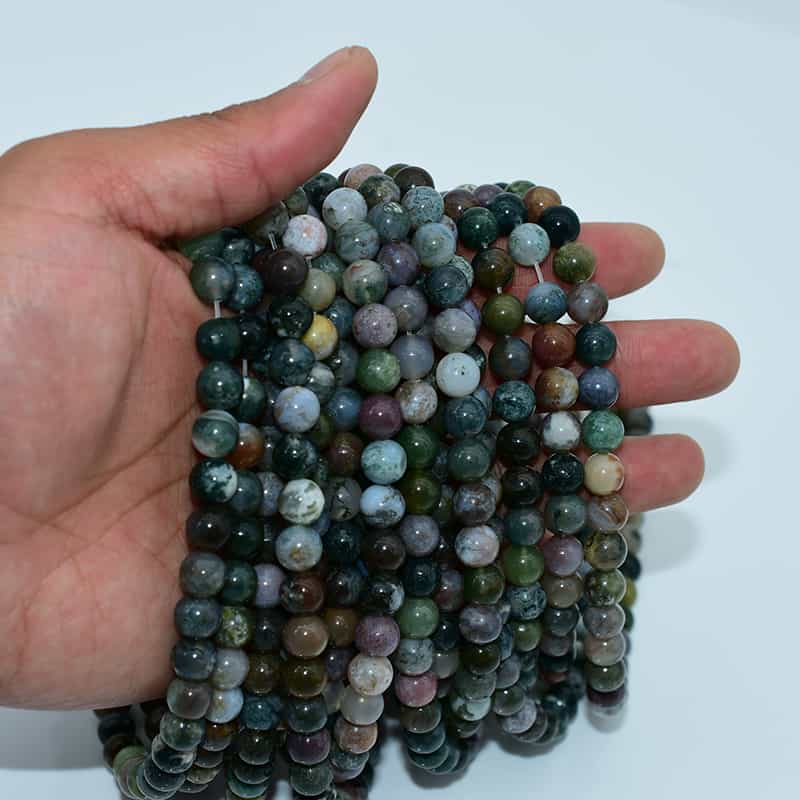 Indian Agate Beads on hand showing size, texture, and natural earthy color mix
