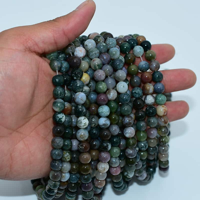 Handheld Indian Agate Beads strands demonstrating bead luster and authentic craftsmanship