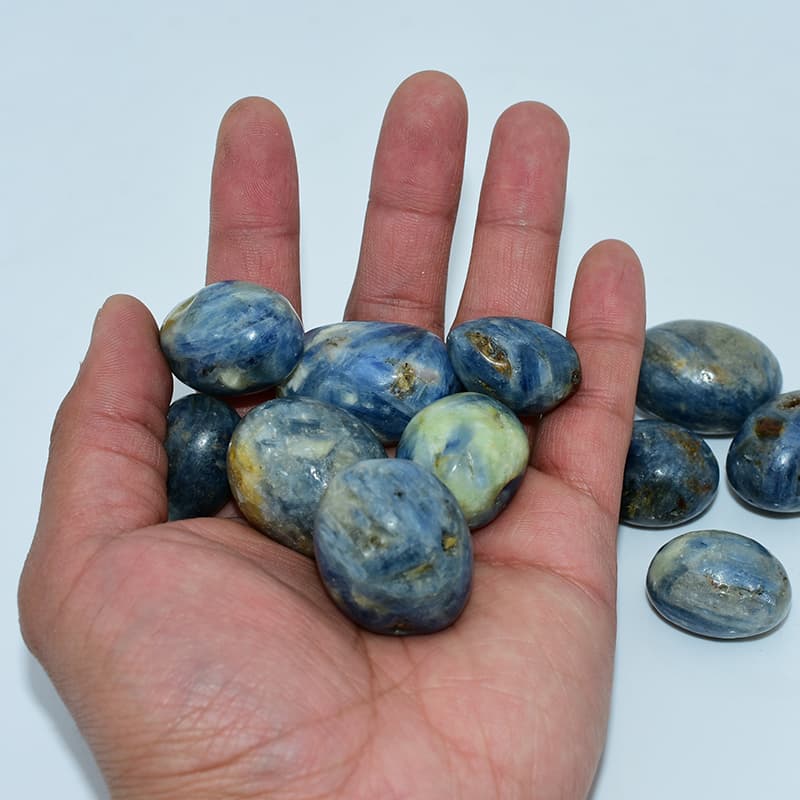 Kyanite Tumbled stones on hand showing size and color