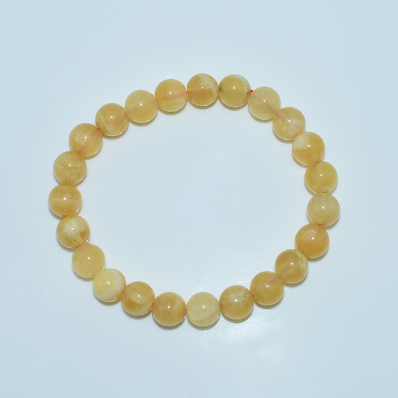 Orange Calcite Bracelet top view showing circular bead arrangement and shine