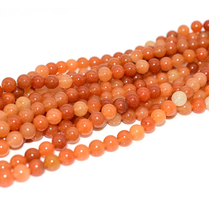 Red Aventurine Beads viewed from side angle showing natural quartz transparency