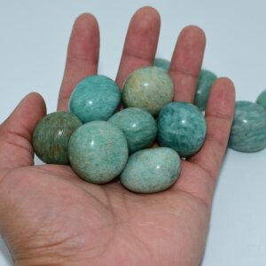 Amazonite Tumbled stones in hand showing 20–30mm wholesale size