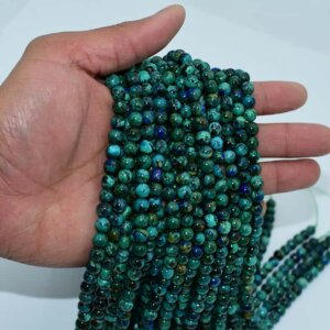 Azurite Beads strands displayed on hand