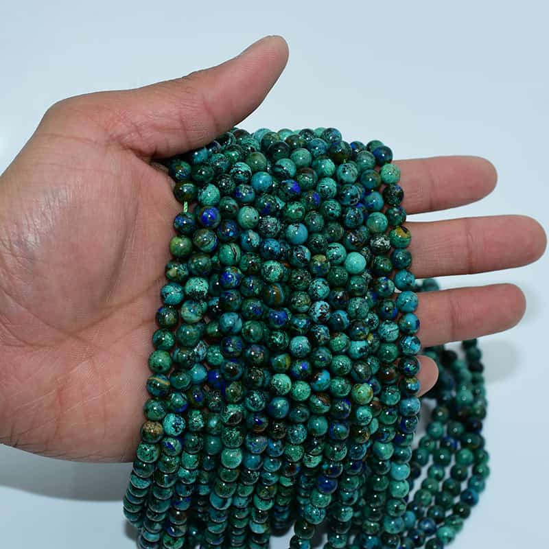 Azurite Beads strands held in hand for size reference