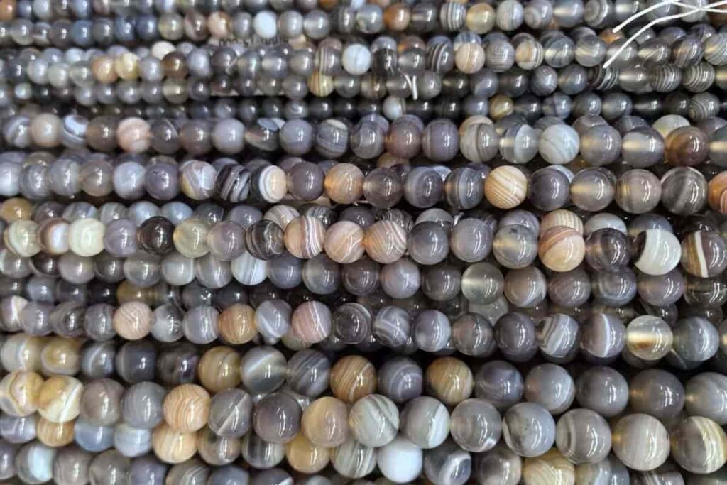 Botswana Agate strand beads for jewelry making, symbolizing the Botswana Agate meaning of stability, protection, and creativity.