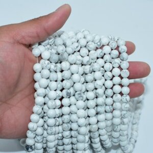 Howlite Beads displayed on hand to show real size, quality and strand density