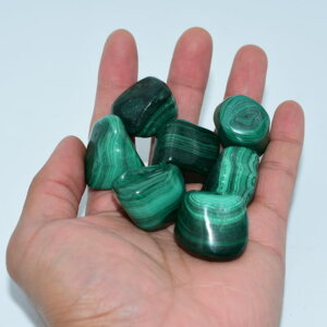Malachite Tumbled Stone on hand showing color and size