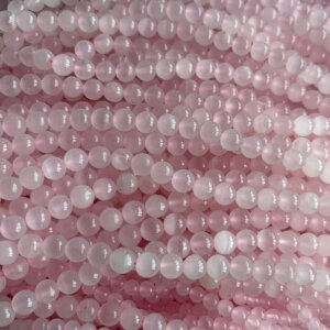 Strand of Pink Calcite beads in soft pastel tones, emphasizing Pink Calcite Meaning and its nurturing emotional energy.