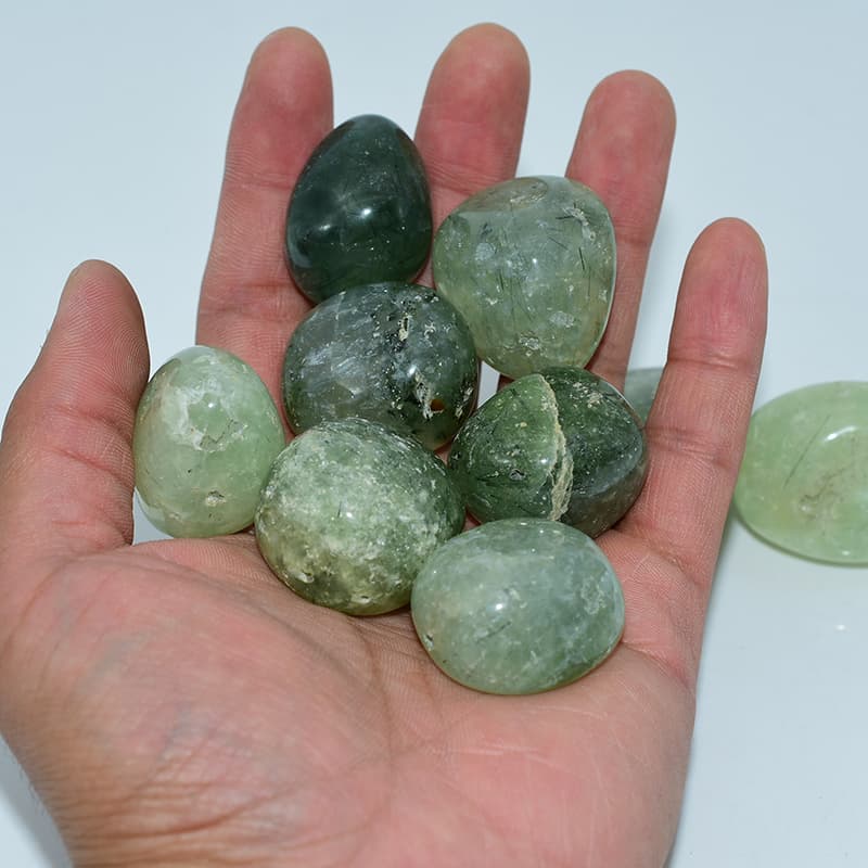 Prehnite Tumbled Stone on hand showing real size and natural translucent texture