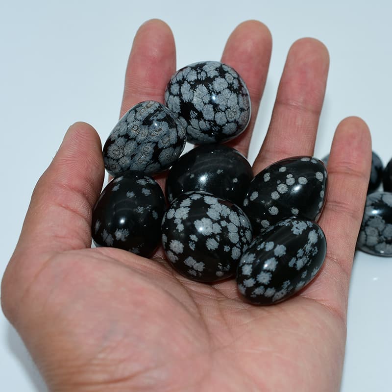 Snowflake Obsidian Tumbled Stone on hand showing size