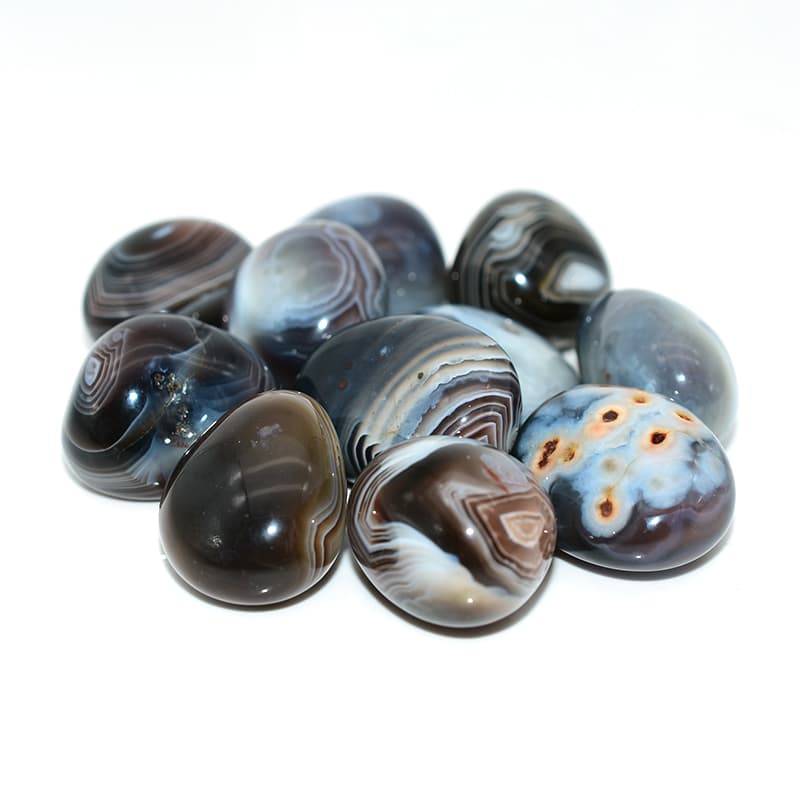Close-up details of Tumbled Botswana Agate showing natural gray and peach band patterns