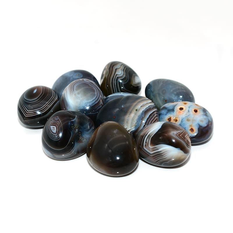 Tumbled Botswana Agate stones viewed from different angles with silky layered texture