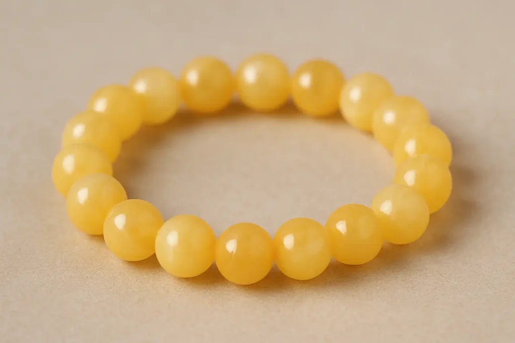 8mm Yellow Calcite bracelet with round polished beads, highlighting Yellow Calcite Meaning for courage and inner sunshine