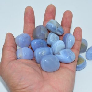 Blue Lace Agate Tumbled stones displayed on hand for size