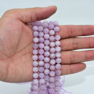 Kunzite Beads shown on hand to display size and natural pastel color
