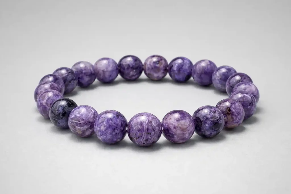 Charoite bracelet with purple beads showcasing Charoite Meaning and natural swirling patterns