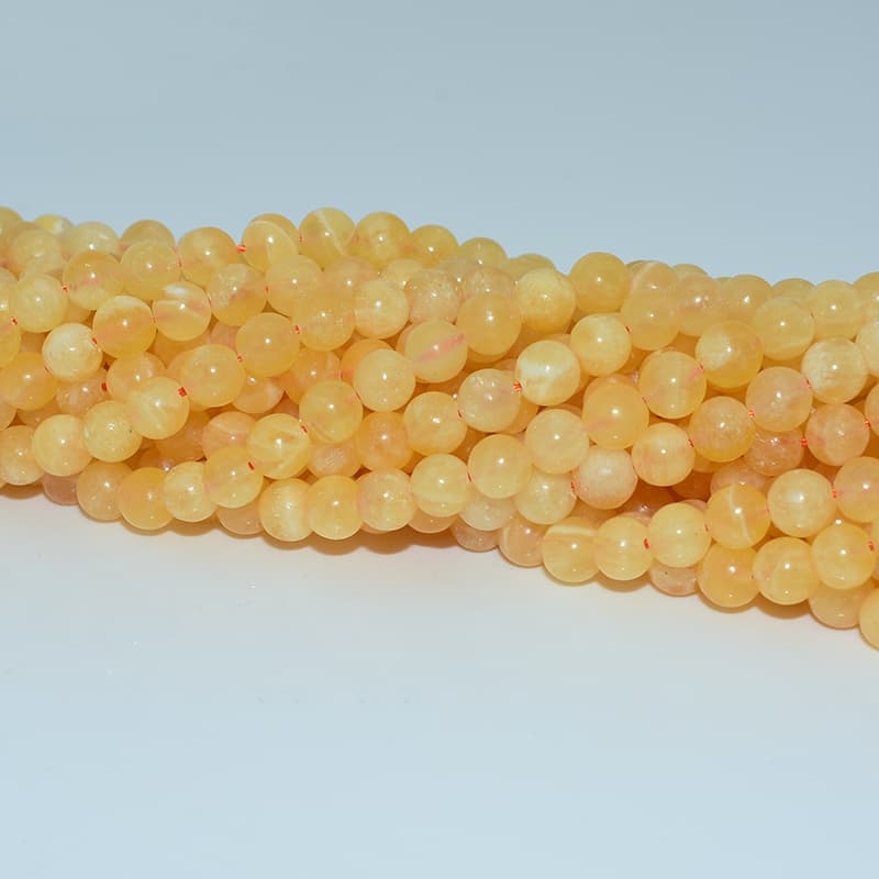 Orange Calcite Beads close-up details showing polish and warm orange tone