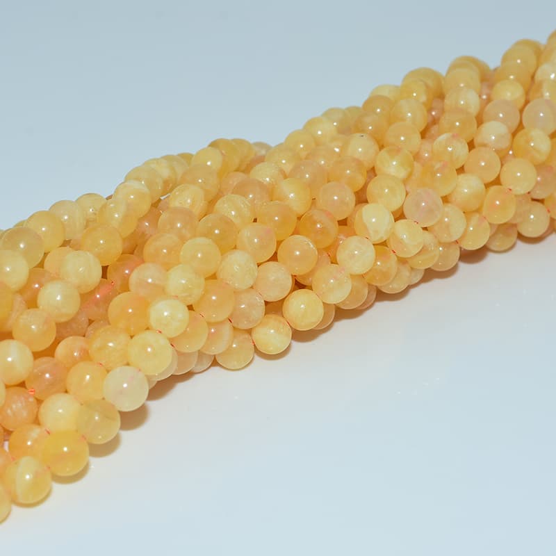 Orange Calcite Beads strands from a different angle to show texture consistency