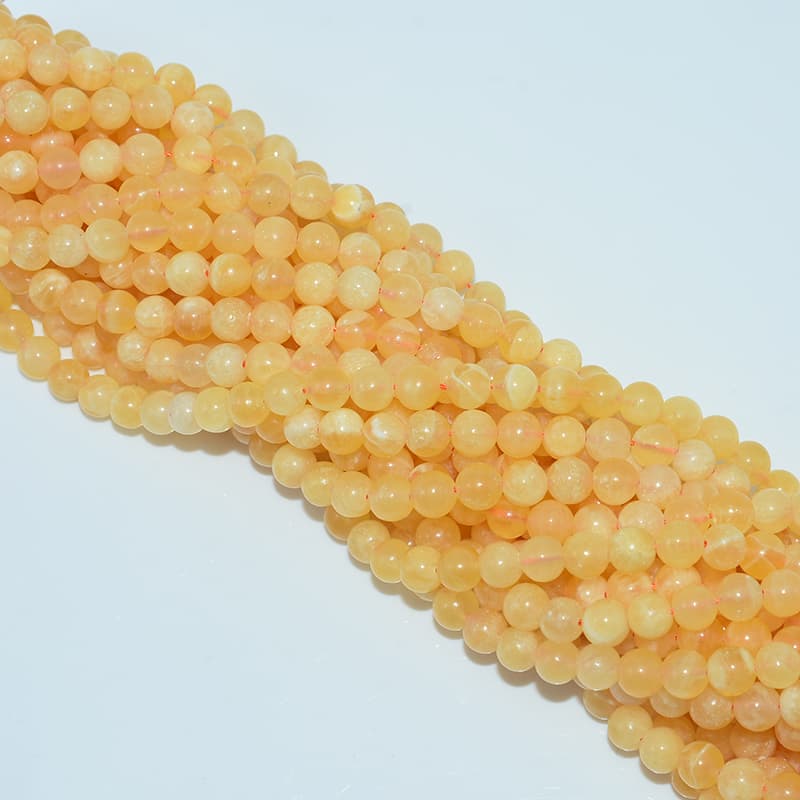 Orange Calcite Beads top view details with drill alignment and finish